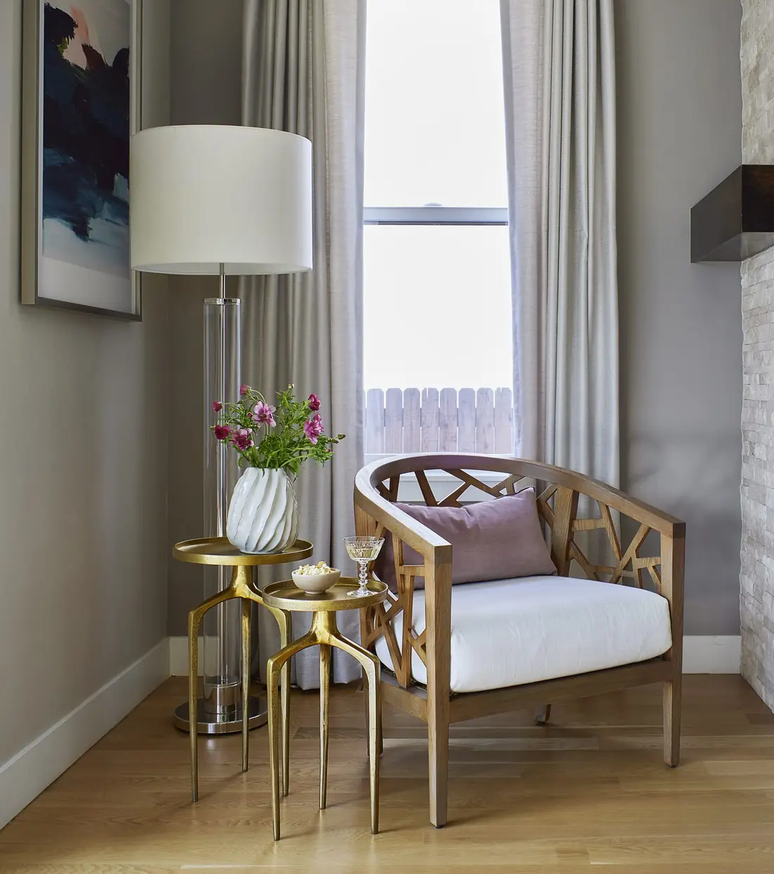 Fretwork lounge chair styled with gilded nesting tables
